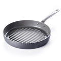 Gray ceramic grill pan with raised ridges, metal handle, and square shape, shown on a white background.