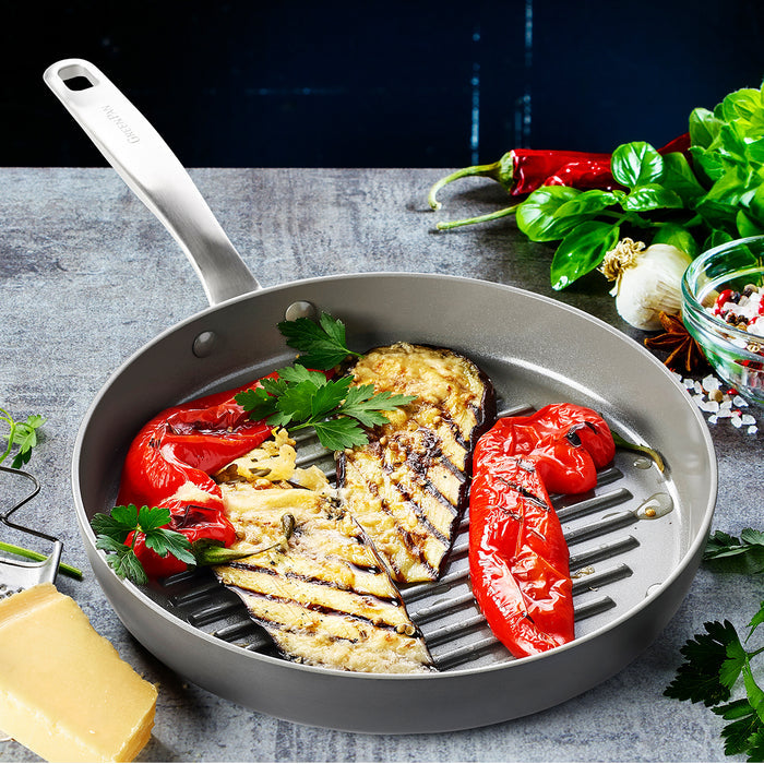 Ceramic nonstick round grill pan with grilled eggplant, red pepper, parsley, herbs, and melted cheese.