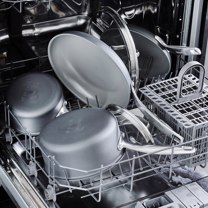 Ceramic square griddle placed in the bottom rack of an open dishwasher.