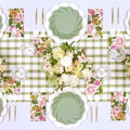 Create a spring-inspired look with the Sophistiplate Garden Rose Table Setting, featuring a green plaid runner, white scalloped plates, green and floral napkins, gold and white cutlery, clear glasses, and white/blush floral centerpieces.