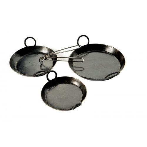 Cast iron skillets stacked on wooden display stand at Pengelly Garden Centre, heavy-duty frying pans for outdoor cooking
