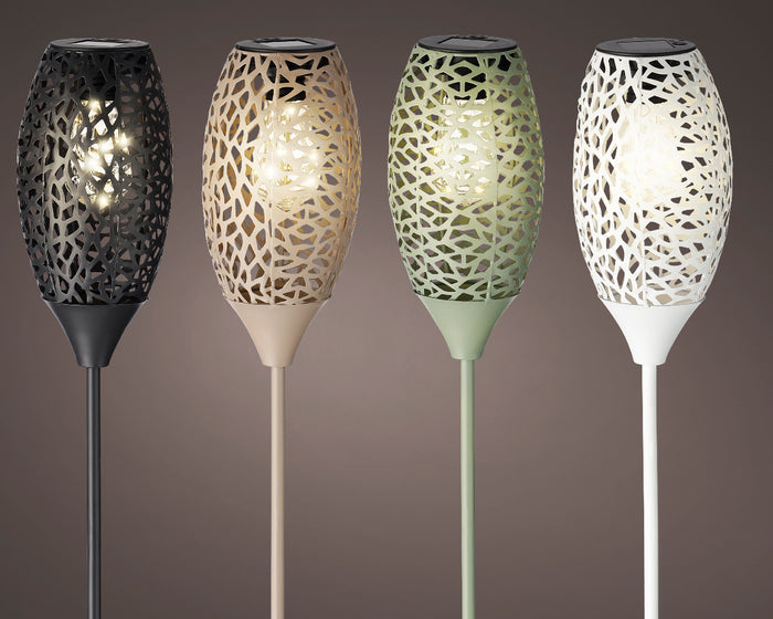 Solar-powered outdoor garden light with decorative perforated metal shade casting patterned light on patio