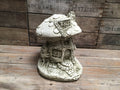 Red and white toadstool mushroom garden ornament on grass