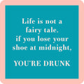 The Lose Your Shoe Coaster by Drinks On Me features white text on a mint-green square with a pink border: "Life is not a fairy tale. If you lose your shoe at midnight, YOU’RE DRUNK." Perfect for bar carts or housewarming gifts.