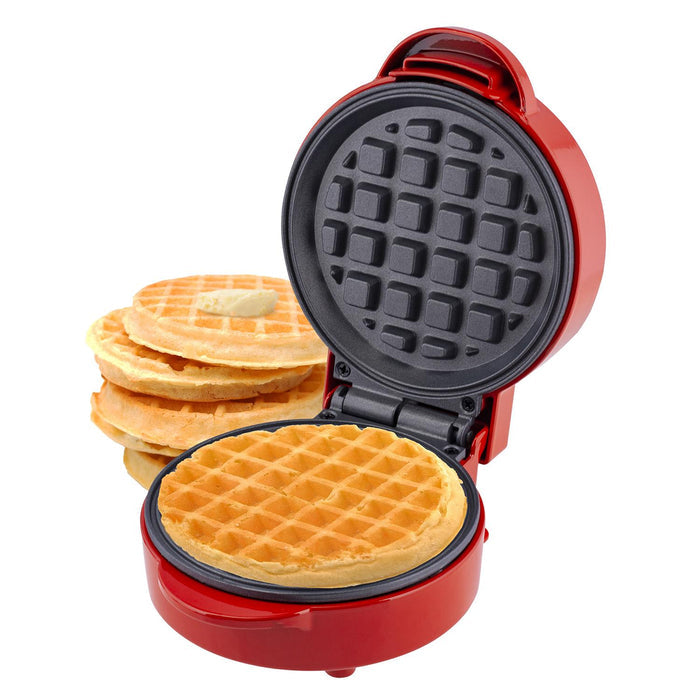 A red mini waffle maker machine with a non-stick cooking plate, open to show the waffle inside. The appliance has a round shape and a power indicator light is visible. - Buy Now Home Mini Waffle Maker Machine