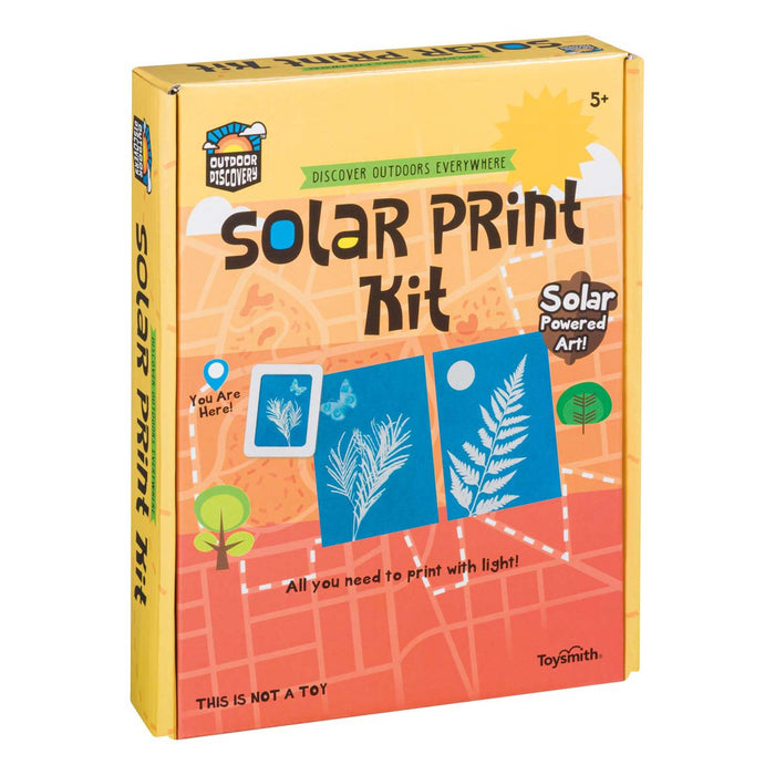 The Outdoor Discovery Solar Print Kit by Outdoor Discovery comes in a yellow box with outdoor-themed graphics, showing leaf sun prints and solar-powered art. The packaging reads "Solar Powered Art!" and "All you need to print with light!" for ages 5+.