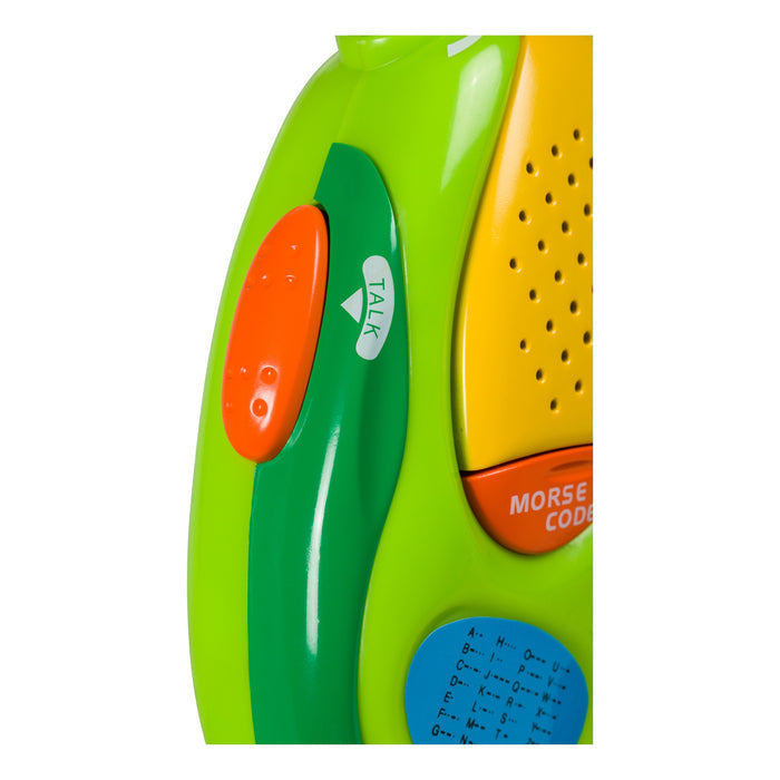 Close-up of an Outdoor Discovery Walkie Talkie by Outdoor Discovery, showing its colorful design with green, yellow, and orange sections, orange and green TALK buttons, a yellow speaker, and part of a Morse code chart.