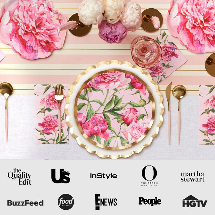 The Pink Peonies Table Setting by Sophistiplate LLC features pink and white designer disposable plates, gold utensils, and peonies. Media logos like BuzzFeed, People, and HGTV appear below on a white background.