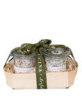 The Savory Salt Duo Gift Set by Bella Cucina features two small glass jars of gourmet seasoning in a wooden basket with straw-like packing and a green “Cucina” ribbon—perfect for elevating your charcuterie board.