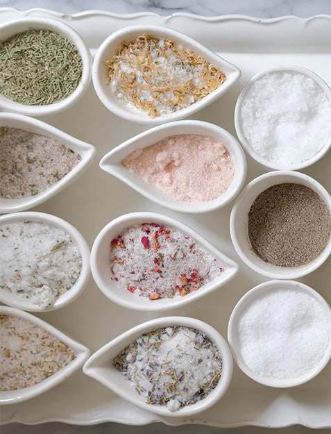 The Bella Cucina Savory Salt Duo Gift Set features two gourmet salt blends, elegantly packaged—an ideal addition to charcuterie boards or kitchen counters for enhancing any dish.