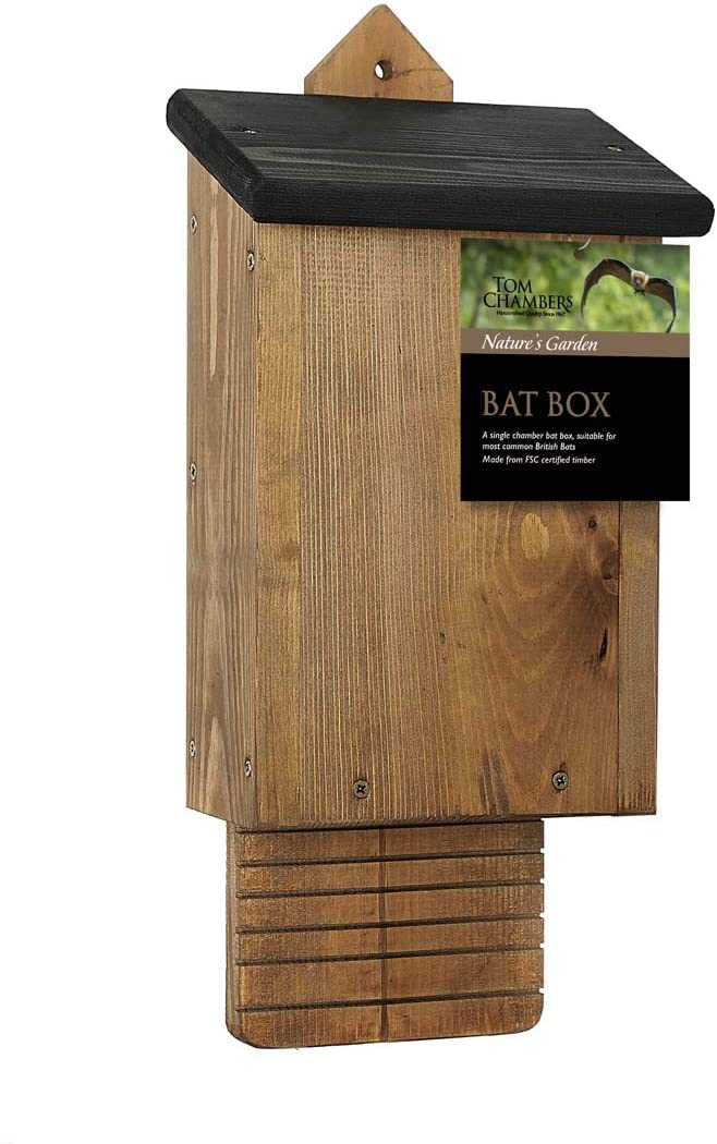 Wooden bat box with sloped roof and entrance slot, mounted on tree providing garden wildlife habitat
