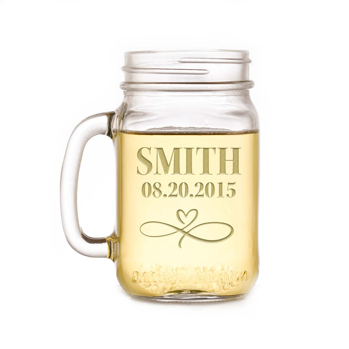 Mason jar mug sand-carved with the name "Smith", a date and an infinity-and-heart flourish, on a white background.